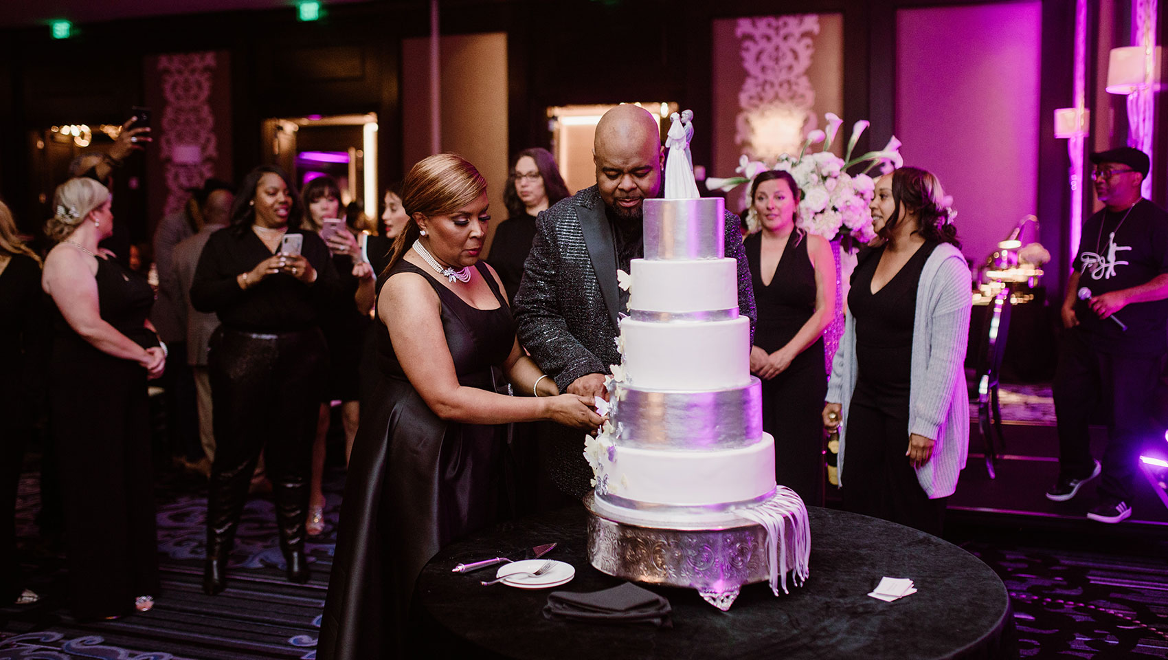 Couple cutting cake at after party