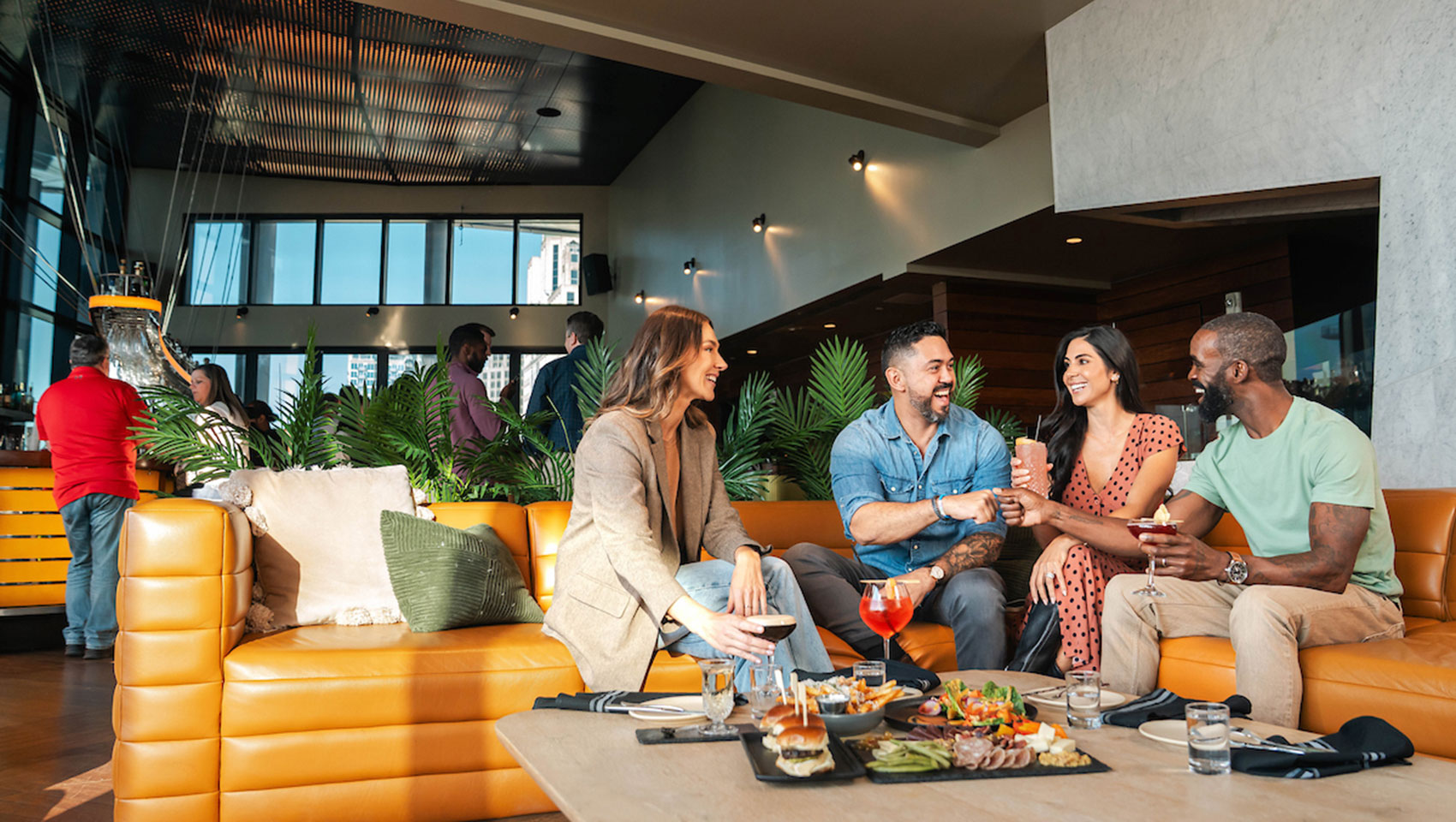 guest drinking and eating at the rooftop bar