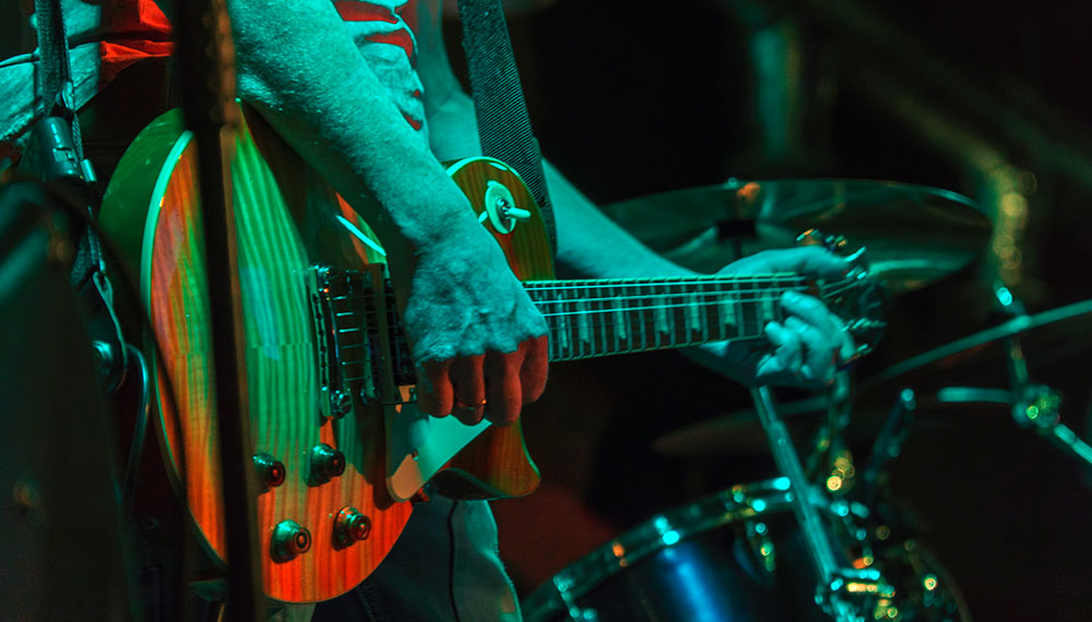 hands of guitar player at concert