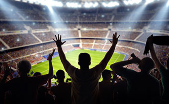 sports fan cheering in large stadium